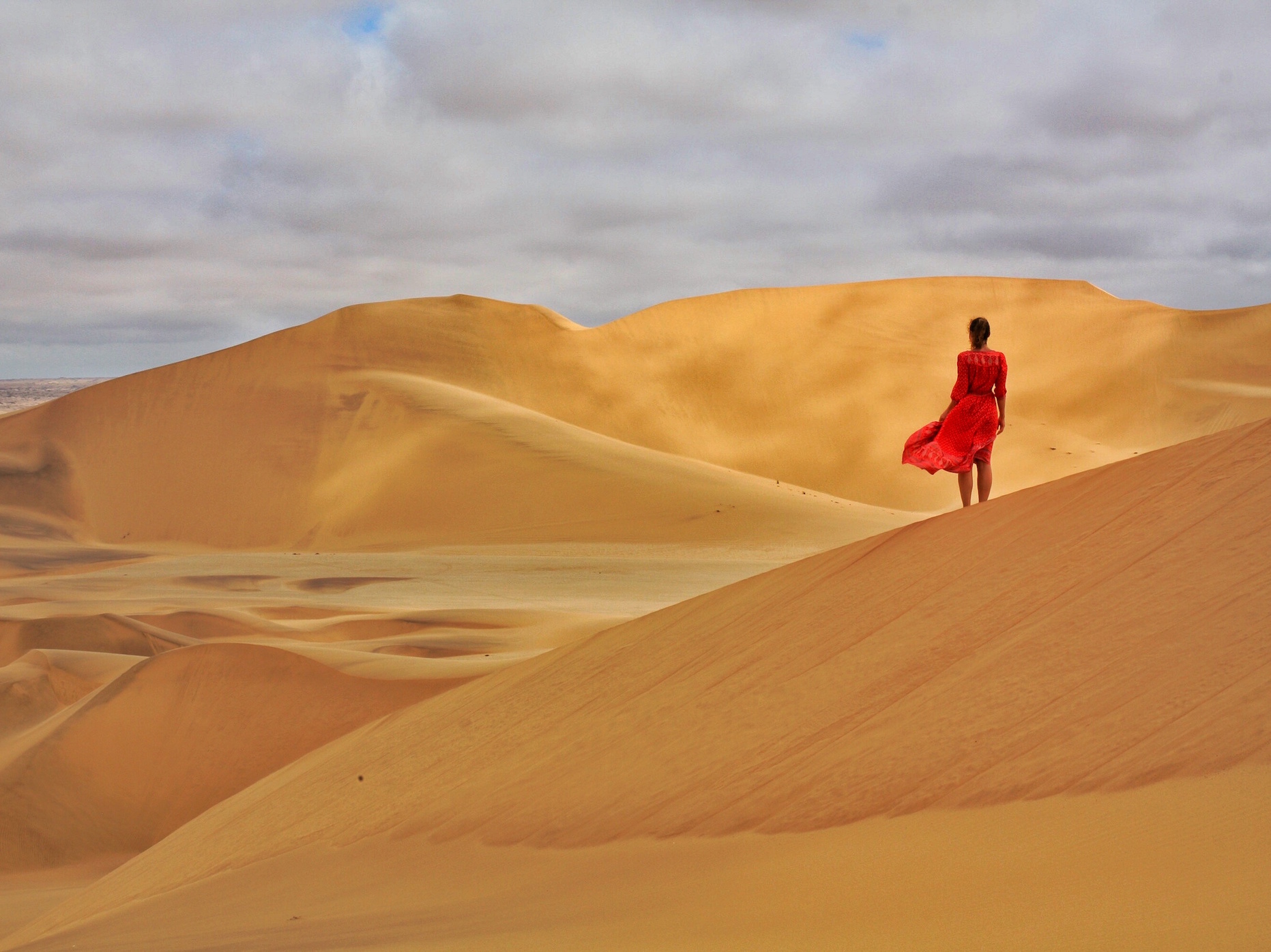 Girl in red at Sand Dunes in Dorob National Park, Namibia