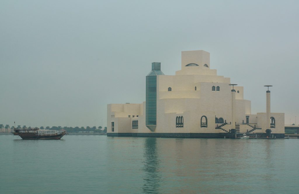 white structure with reflection in the water of Museum of Islāmic Art