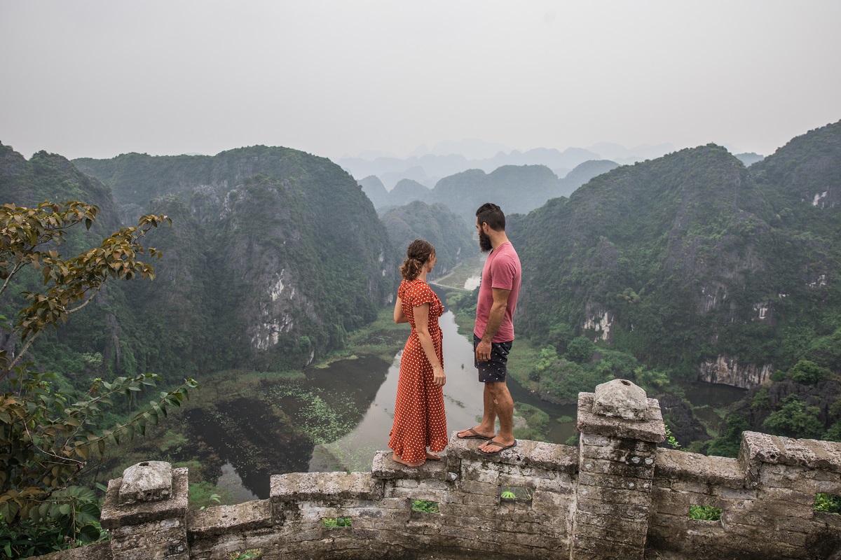 Couple looking back at Ninh Binh at Moa Caves